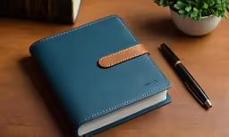 the small notebook is beside the small pen