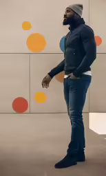 a man standing and leaning on his back in a room with circles