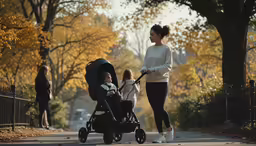 a mom pushing her child in a stroller and walking in the park