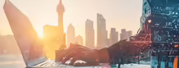 a person typing on their laptop while in the city