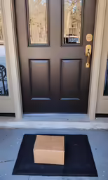 a box sitting on the ground in front of a door