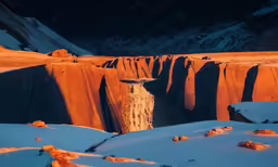 an area with large rock formations and bright orange hue