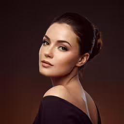 a woman in a black dress posing for a photo