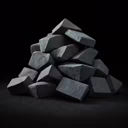 grey rocks stacked in a pile against a dark background