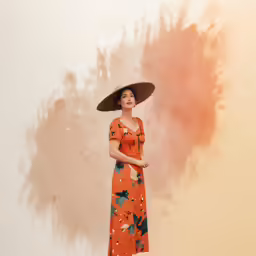 a woman wearing a straw hat and orange dress