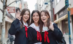 three girls in black outfits pose for a photo