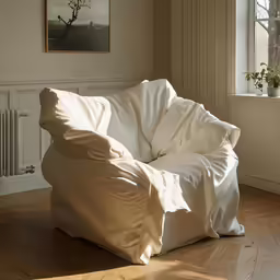 a large white bean bag chair that is partially covered