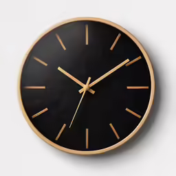 a black and gold wall clock is hanging on the wall