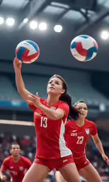 a female volleyball player reaching to hit a ball