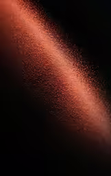 red liquid streaks against black background