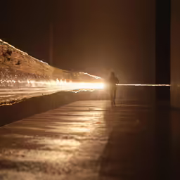 a person standing near water fountain in night