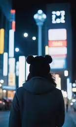 woman with ears back facing away from lighted building