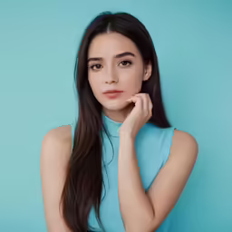 a girl in a blue dress is posing for a photo