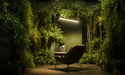 a green room with trees, plants and a chair