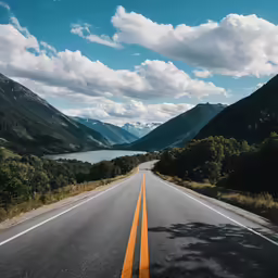 there is an empty road going through mountains
