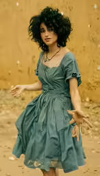 a woman in a green dress is standing by a wall