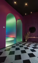 the room has many colored lights and black and white floor