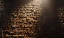 a brick wall illuminated by a light from the side