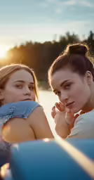 two women sitting on a boat in the water