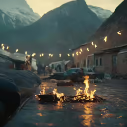 a camp fire is lit on a snowy street