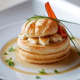 an appetizing pastry with meat and vegetables on top