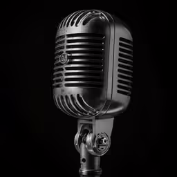 an old style microphone with a black background