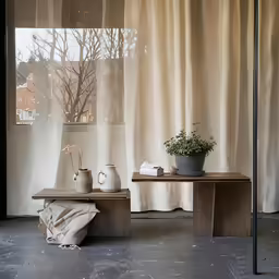 some white vases sitting on top of a table