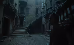 a man standing in a very dark alley
