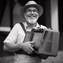 man holding an old style radio with an open lid