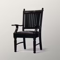 a black chair sitting in front of a white wall