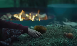 a woman laying down with a large ball in her hands