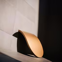 an object standing on the ground next to a wall