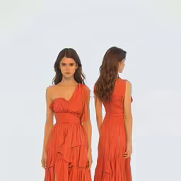 two models wearing one orange gown and the other orange