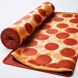 an orange rug with a red mat and a roll of material