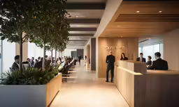 people sitting at tables in an office lobby