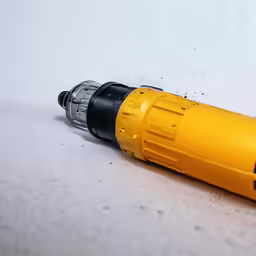 an electric drill sitting on top of a table