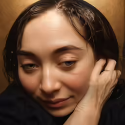 a woman with a long dark hair is smiling