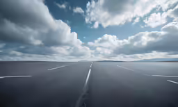 some kind of empty road under a cloudy sky