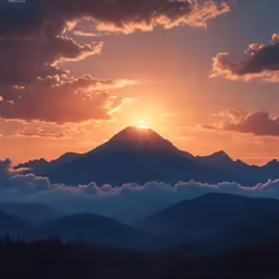 a view of the sun setting over mountains from below