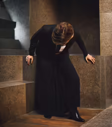 the woman is leaning on the wall in the elevator