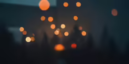 blurry shot of the night sky with a tree in front