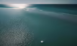 a boat on the water next to the shore