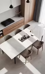 an all white kitchen with wooden cabinets and a marble table