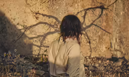 a person standing next to a wall with no one