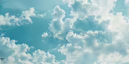 a plane flying over some fluffy clouds in the sky
