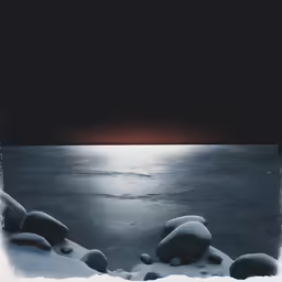 rock formations next to the water at night