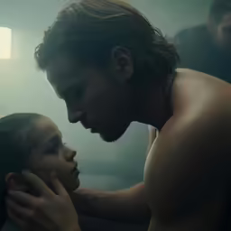 two people are in a bathroom, one is touching the other hand