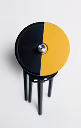 a small stool with yellow and black accents