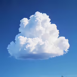 a huge cloud in the blue sky
