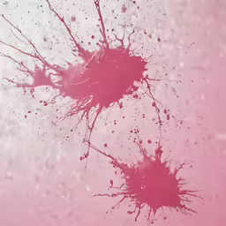 red ink splatters in pink ink with a blurry background